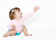 The little girl with the stretched hand on a light background