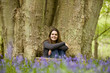 A young woman sitting under a tree, relaxing