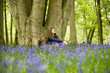 A young woman sitting under a tree, relaxing