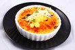 Delicious french dessert creme brulee in porcelain bowl