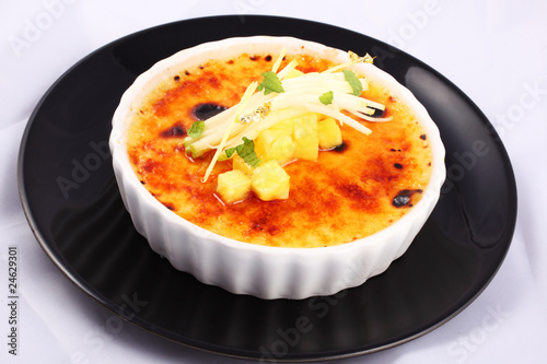 Photo: Delicious french dessert creme brulee in porcelain bowl Delicious french dessert creme brulee in porcelain bowl