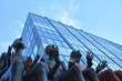 Sculpture of group of people with heads up.