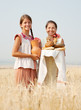 Women  with bread at field
