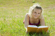 Blond girl on green field