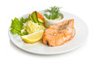 Fried trout steak with a vegetable side dish and sauce