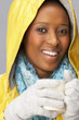 Young Woman Drinking Hot Drink Wearing Yellow Raincaot