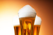 Beer glasses against the colorful gradient background Beer glasses against the colorful gradient background