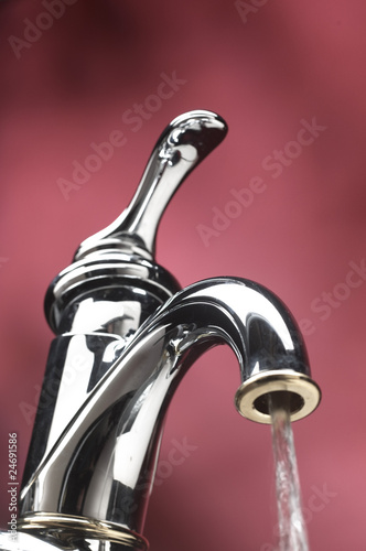 Photo: running water out of tap of sink faucet running water out of tap of sink faucet