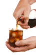 man's hand pours a drink into a glass