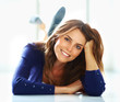 Portrait of relaxed young lady lying on floor smiling