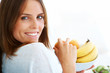 Pretty young woman holding a fruit bowl