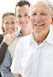 Old man smiling with his son and daughter in background
