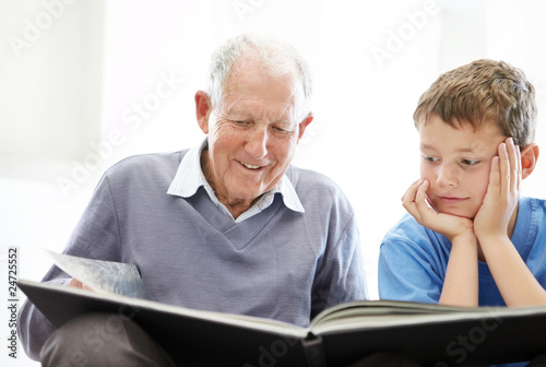 Photo: Grandfather and his grandson reading a story book Grandfather and his grandson reading a story book