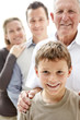 Sweet little boy smiling while his family standing in background