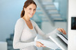 Young businesswoman making copies on the photocopy machine