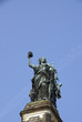 Old Angel Monument in front of clear sky.