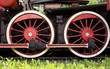 big red rusty wheels of old steam engine