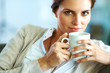 Pretty young female having a cup of coffee