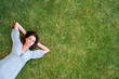 An attractive young lady sleeping on grass - Copyspace