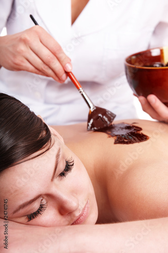 Photo: Girl having chocolate body mask . Girl having chocolate body mask .
