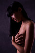 The sexual naked girl hides a breast