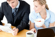 Happy couple of businesspeople having breakfast reading the news Happy couple of businesspeople having breakfast reading the news