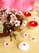 spa composition of candles, stones and flowers