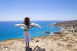 Girl standing on the top of the hill above teh sea Girl standing on the top of the hill above teh sea