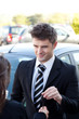 Charming salesman giving a customer car keys