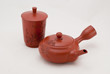 red ceramic chinese tea cups on a white background.
