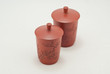 red ceramic chinese tea cups on a white background.