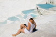 Woman sitting on white stones