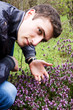 a young man near the flower beds