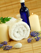 spa composition of towel, flowers and candles