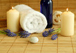 spa composition of towel, flowers and candles