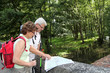 Foto: Senior couple looking at map on a bridge Senior couple looking at map on a bridge