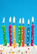 Colorful birthday candles on blue background