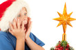 Young boy is excited while looking at Christmas tree