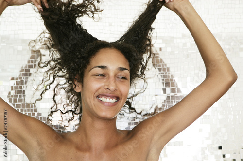Photo: Portrait of female playing with her hair Portrait of female playing with her hair