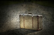 Old suitcase left on a dirt road