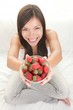 Woman showing fresh strawberries