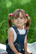 Little girl in jeans with blue eyes outdoor