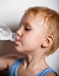 Photo: Quench thirst. The boy is drinking mineral water from bottle Quench thirst. The boy is drinking mineral water from bottle