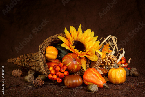 Photo: Cornucopia with pumpkins on brown background Cornucopia with pumpkins on brown background