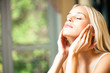 Young beautiful smiling woman applying creme Young beautiful smiling woman applying creme