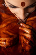 Woman covered in melted chocolate tastes chocolate bar and enjoy