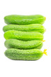 row of fresh cucumbers isolated over white