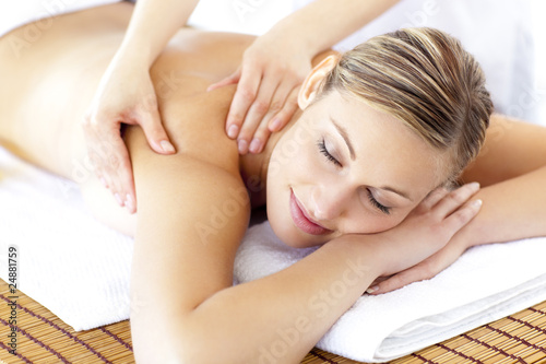 Photo : Relaxed smiling woman receiving a back massage Relaxed smiling woman receiving a back massage