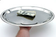cash money served on a silver tray
