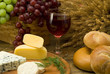 Glass of red wine and cheese on a cheese board